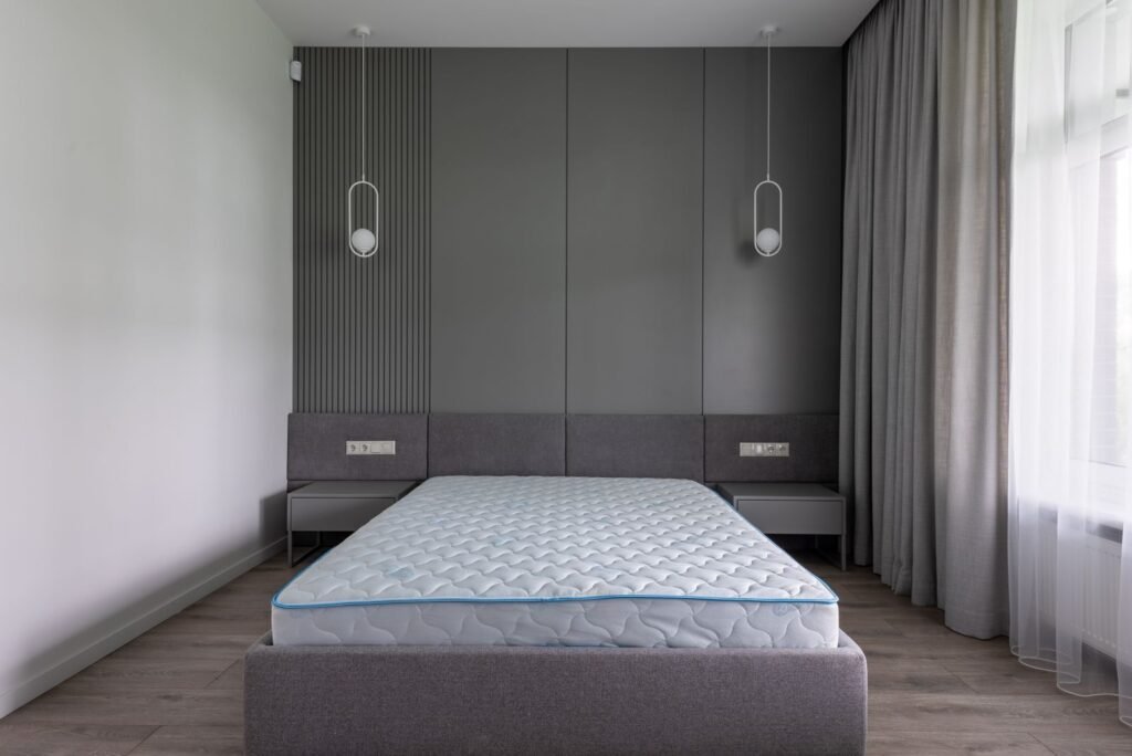 Compact bedroom with a small bed set against a panelled wall
