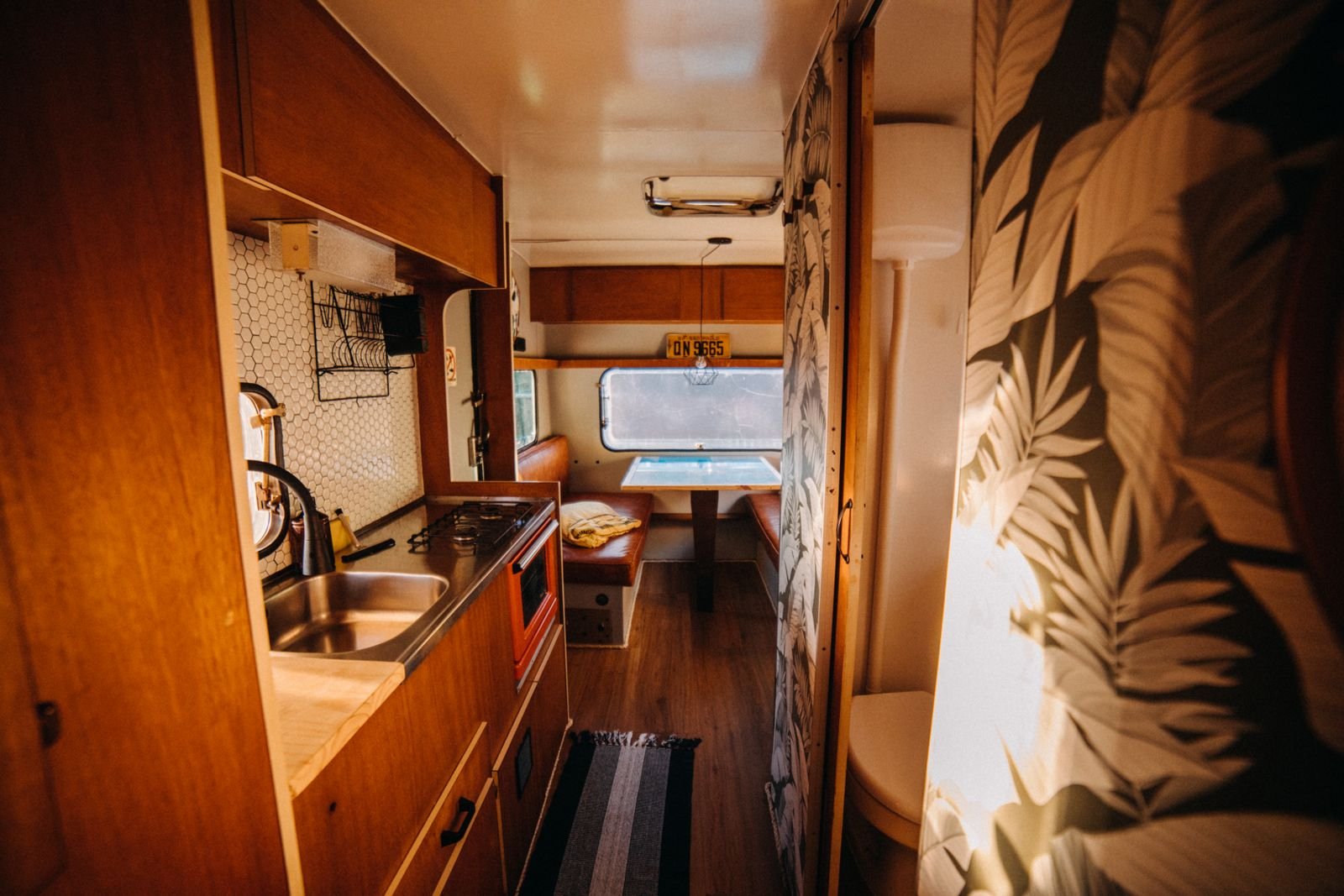 Compact caravan interior showing the kitchen area and side window