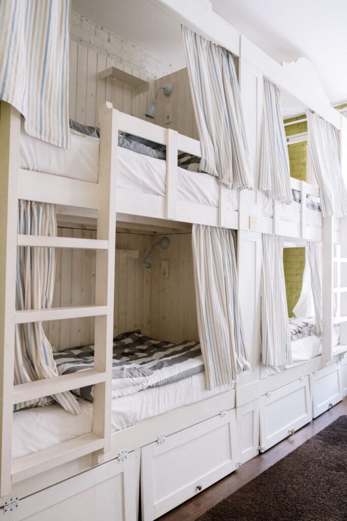 Bunk beds with privacy curtains in a shared dormitory room