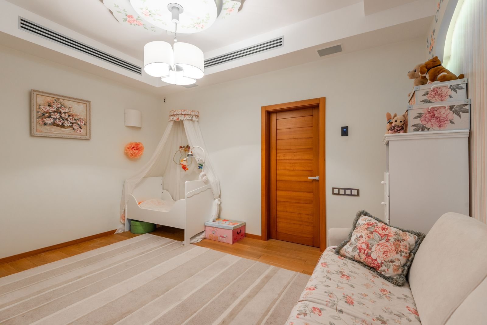 Nursery with a wooden cot, wardrobe and soft furnishings