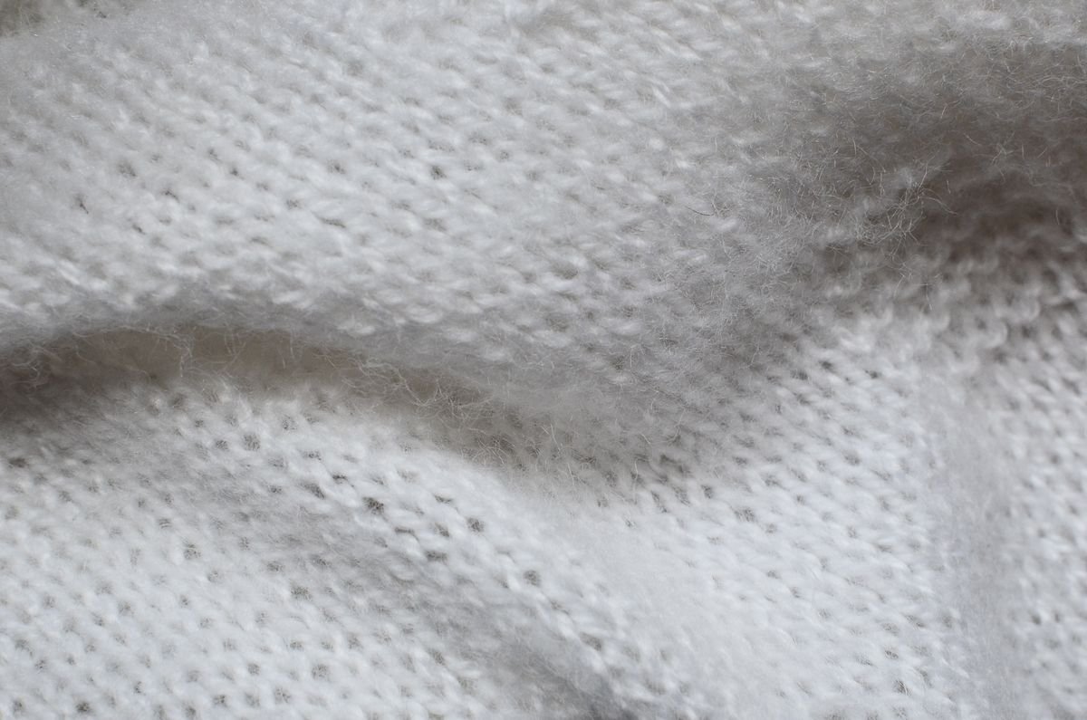 Close-up of a pale blue knitted blanket weave