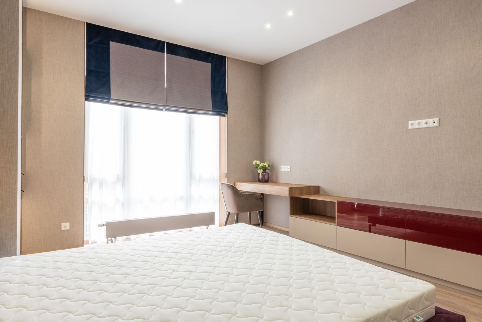 Small bedroom with a bed, built-in desk and window