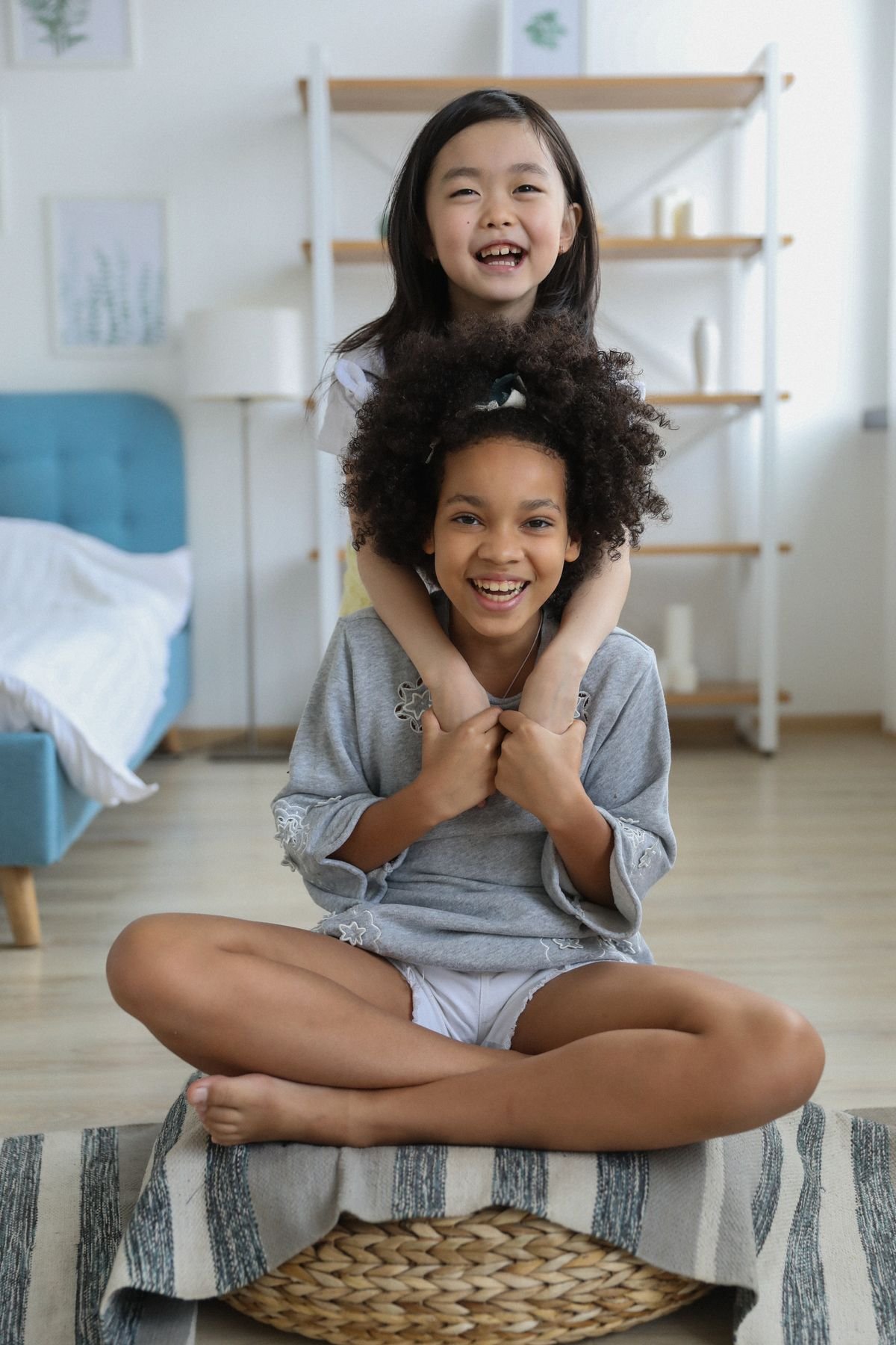 Smiling child lying on white bedding